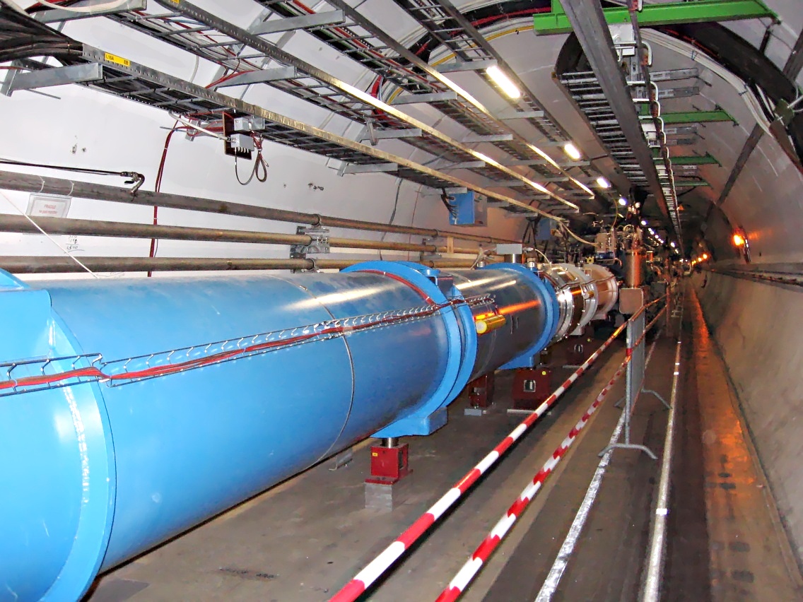 The interior of the Large Hadron Collider tunnel at CERN, showing the blue superconducting magnet array running through the 27-kilometre ring.